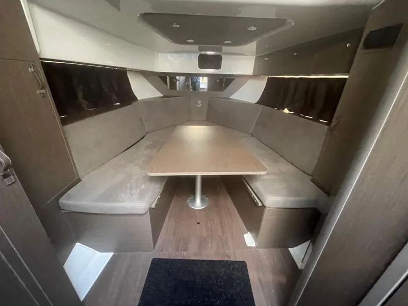Slide: The Image of 2024 Beneteau Gran Turismo 32 interior with cozy seating and central table. - 3