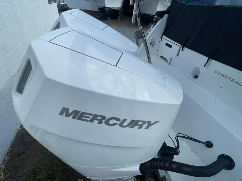 Slide: The Image of 2024 Beneteau Gran Turismo 32 with dual Mercury outboard engines, docked outdoors. - 33