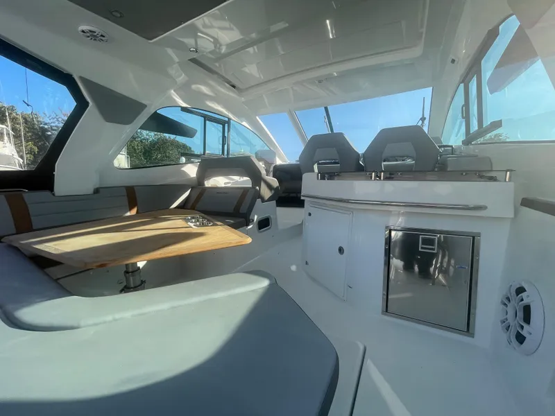 Slide: The Image of 2024 Beneteau Gran Turismo 32 interior with seating, table, and modern amenities. - 4