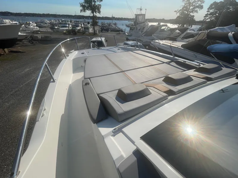 Slide: The Image of 2024 Beneteau Gran Turismo 32 yacht with sun deck, docked at marina. - 5