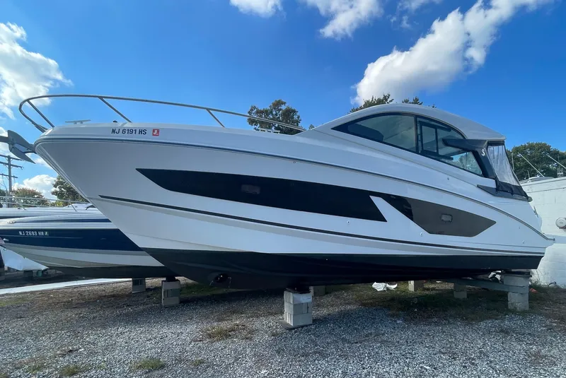 Slide: The Image of 2024 Beneteau Gran Turismo 32 boat on display under a clear blue sky. - 6