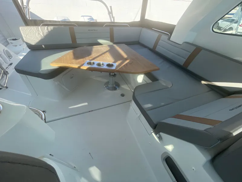 Slide: The Image of 2024 Beneteau Gran Turismo 32 interior with sleek seating and wooden table. - 8