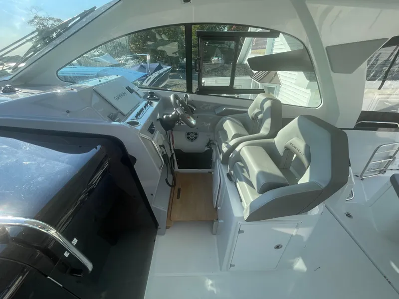 Slide: The Image of 2024 Beneteau Gran Turismo 32 cockpit with modern helm and dual seating. - 9