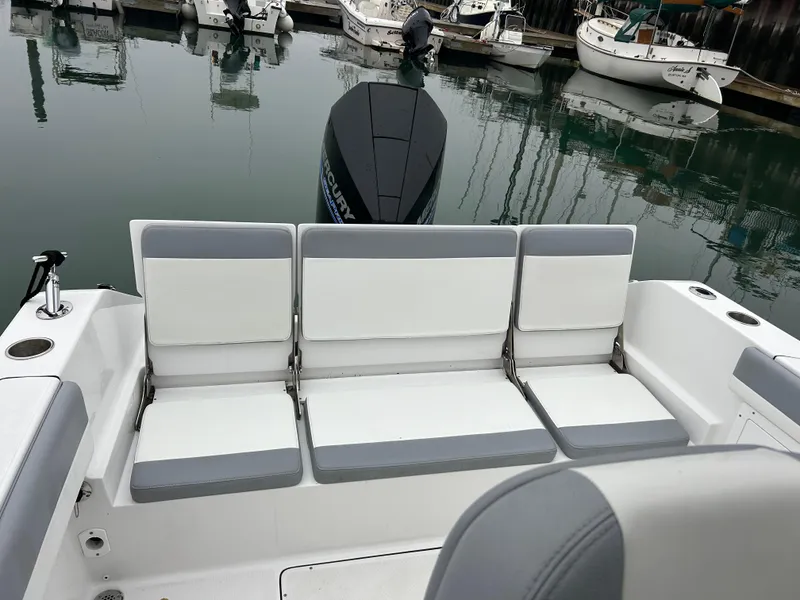 Slide: The Image of 2021 Release 240RX boat with cushioned seating, docked in marina. - 10