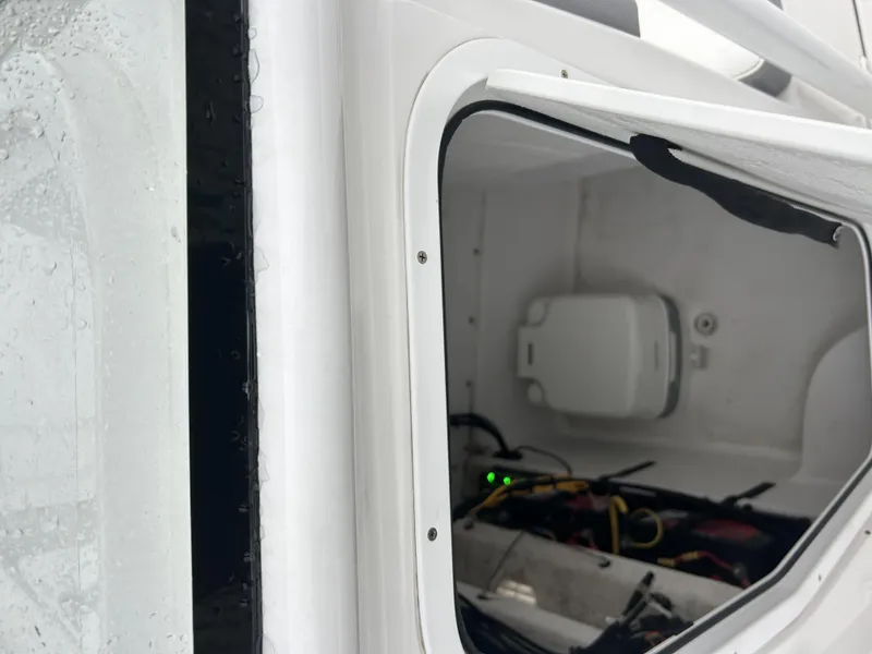 Slide: The Image of Interior view of a 2021 Release 240RX boat compartment with wiring and equipment. - 11