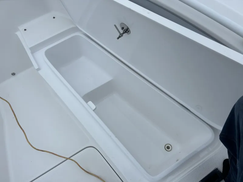 Slide: The Image of Open storage compartment on 2021 Release 240RX boat. - 15