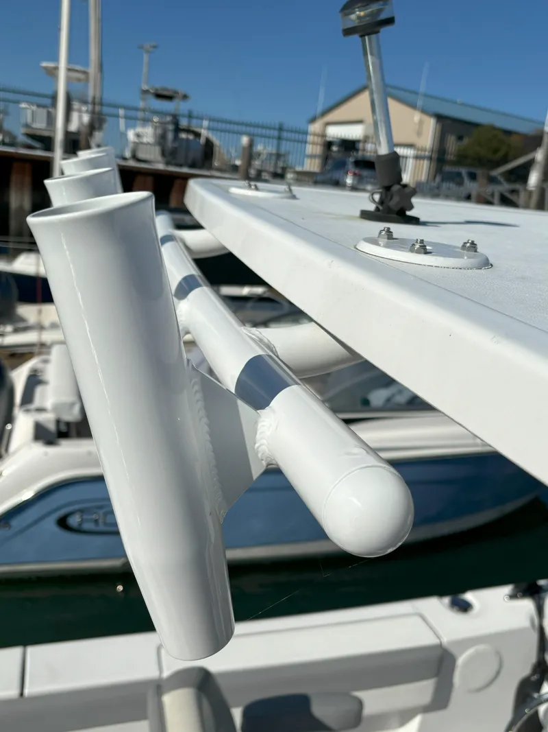Slide: The Image of Close-up of a 2021 Release 240RX boat's rod holder in a marina. - 17