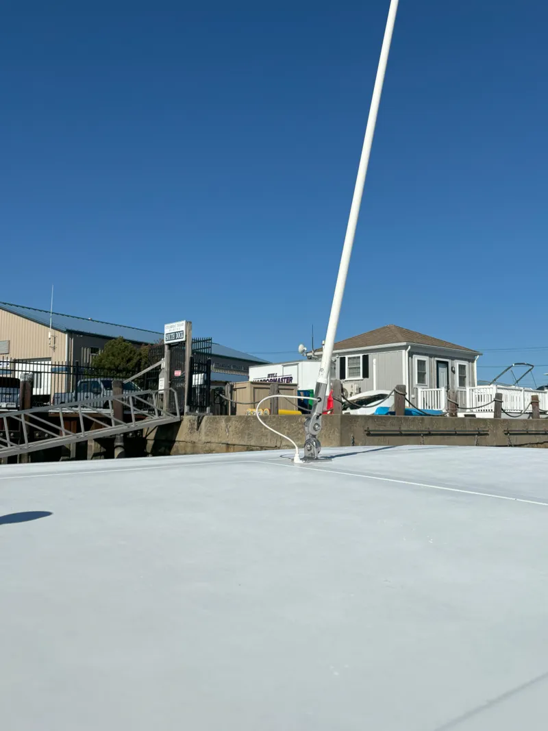 Slide: The Image of 2021 Release 240RX boat docked at marina under clear blue sky. - 18