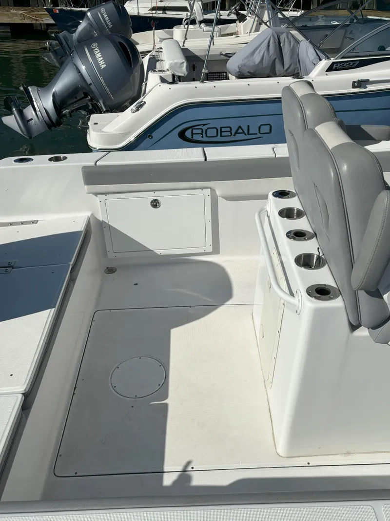 Slide: The Image of 2021 Release 240RX boat interior with seating and storage, docked near Robalo boat. - 19