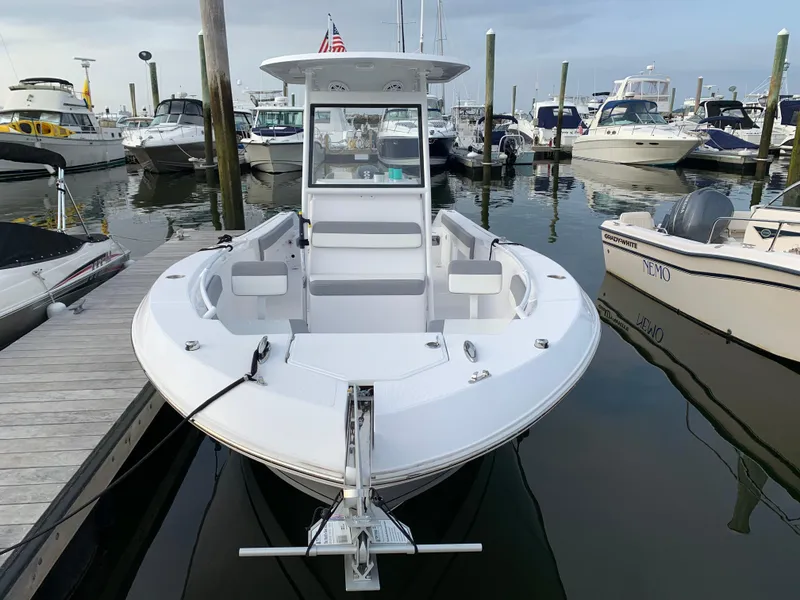 Slide: The Image of 2021 Release 240RX boat docked in a marina, surrounded by other vessels. - 2