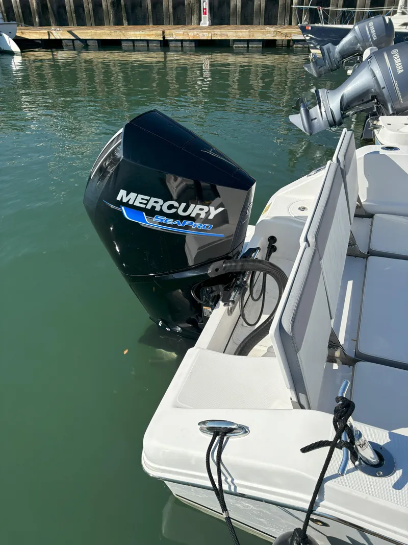Slide: The Image of 2021 Release 240RX boat with Mercury outboard engine docked in marina. - 20
