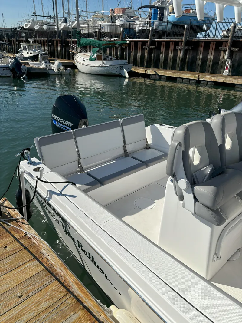 Slide: The Image of 2021 Release 240RX boat docked at marina with Mercury engine. - 21