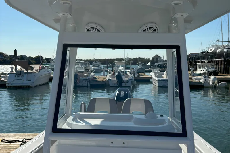Slide: The Image of 2021 Release 240RX boat docked at marina with scenic waterfront view. - 25