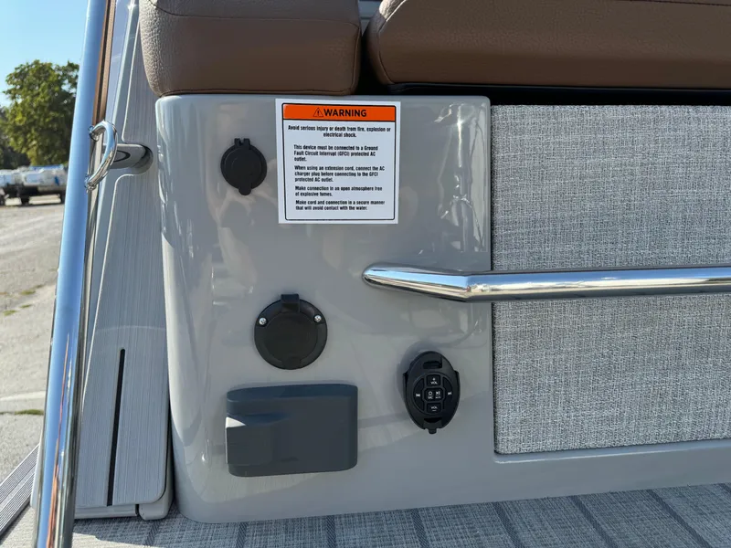 Slide: The Image of 2025 Balise Helix 24L boat dashboard with warning label and control panel. - 11
