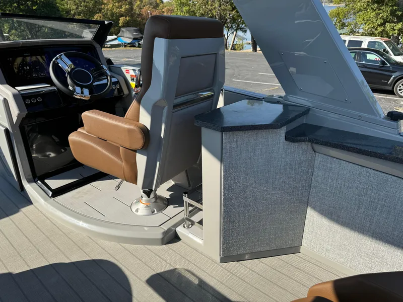 Slide: The Image of Interior of 2025 Balise Helix 24L boat with modern steering and seating. - 13