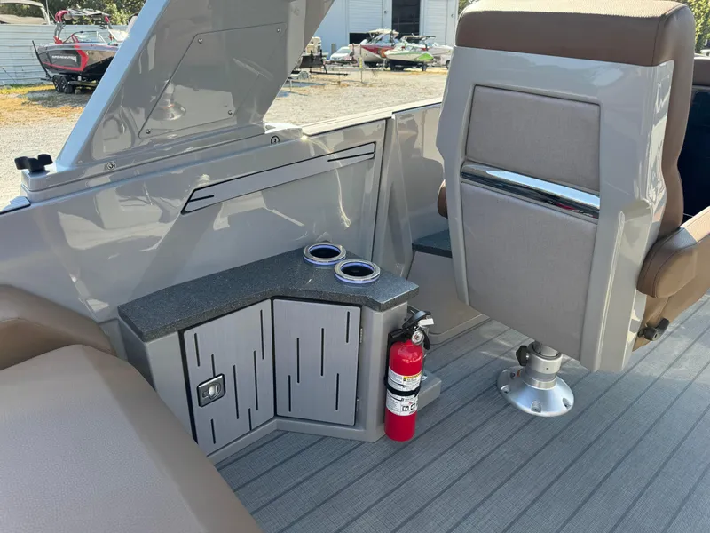 Slide: The Image of 2025 Balise Helix 24L boat interior with seating, storage, and fire extinguisher. - 14