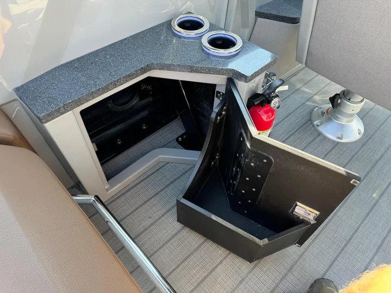 Slide: The Image of Balise Helix 24L 2025 interior storage compartment with cup holders and fire extinguisher. - 15