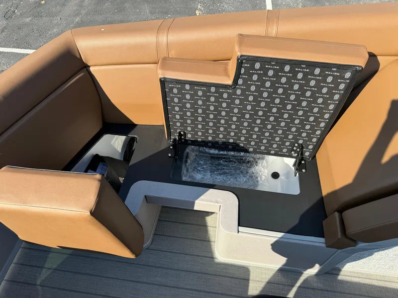 Slide: The Image of Balise Helix 24L 2025 boat interior with tan seating and storage compartment. - 16