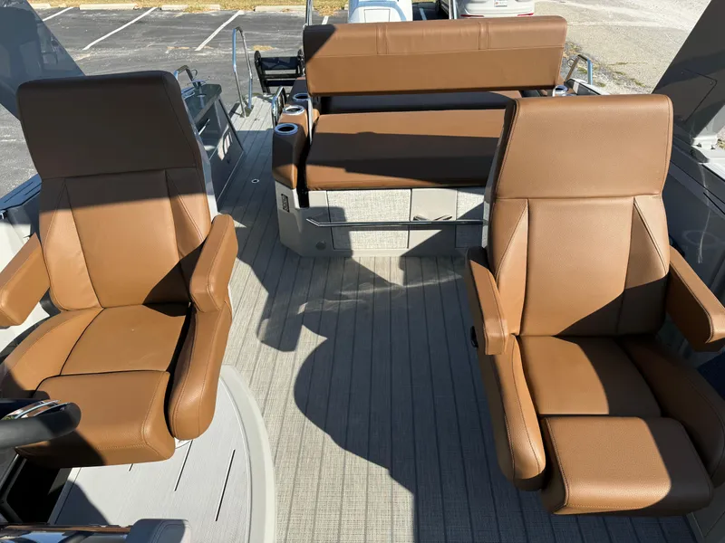 Slide: The Image of 2025 Balise Helix 24L boat interior with brown leather seats. - 23