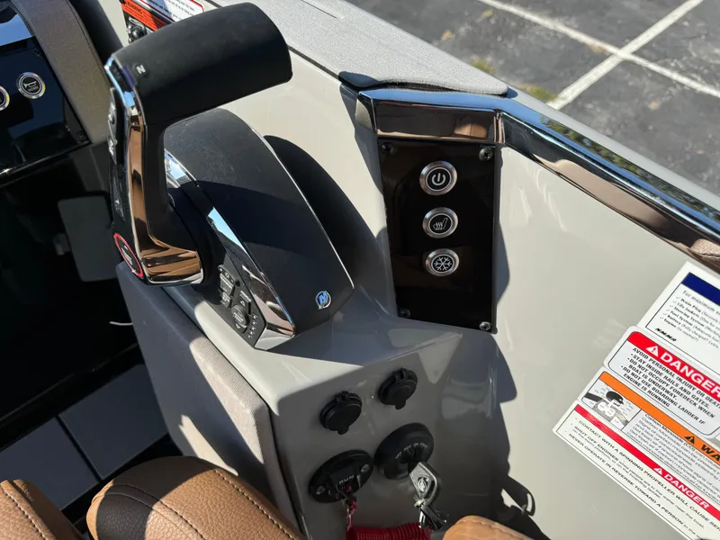 Slide: The Image of Control panel of 2025 Balise Helix 24L boat with throttle and warning labels. - 28