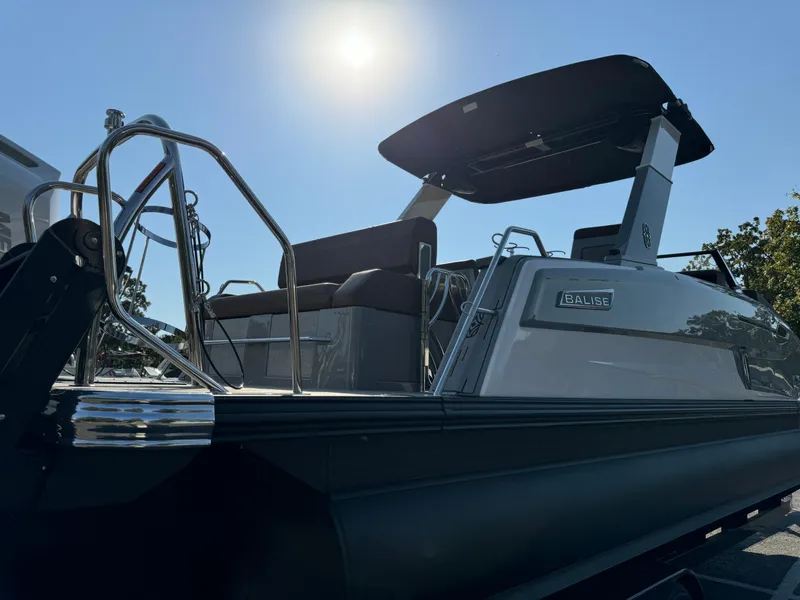 Slide: The Image of 2025 Balise Helix 24L boat with sleek design under bright sun. - 4