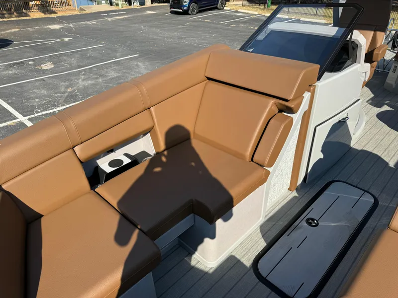 Slide: The Image of Balise Helix 24L 2025 boat interior with brown leather seating and cup holder. - 8
