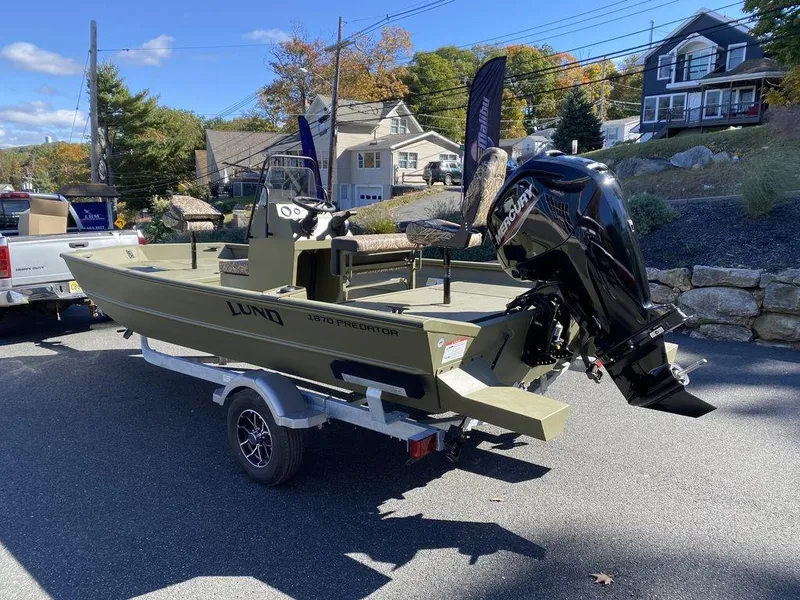 Slide: The Image of 2025 Lund 1870 Predator Z1870C Center Console boat on trailer, outdoor setting. - 4