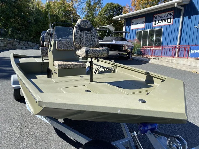 Slide: The Image of 2025 Lund 1870 Predator Z1870C Center Console boat on trailer, outdoors. - 6
