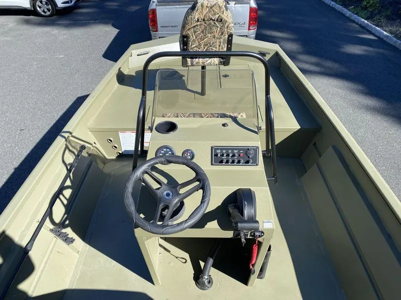 Slide: The Image of 2025 Lund 1870 Predator Z1870C Center Console boat interior with steering wheel and controls. - 9