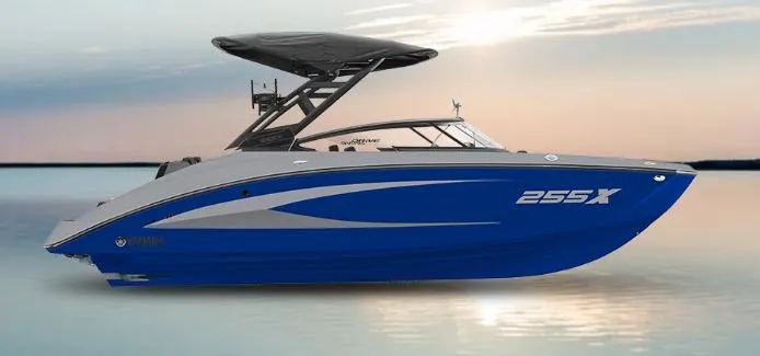 Slide: The Image of 2025 Yamaha Boats 255XD in blue on calm water at sunset. - 16