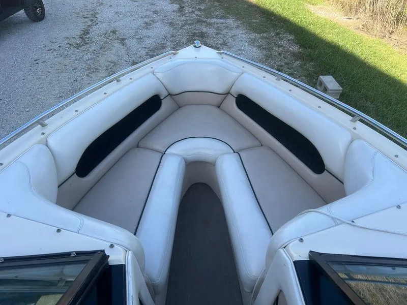 Slide: The Image of 1999 Malibu Sunsetter VLX boat interior with white cushioned seating. - 4