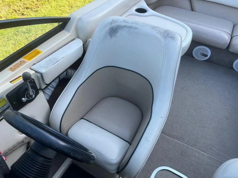 Slide: The Image of 1999 Malibu Sunsetter VLX boat interior with white leather seats and steering wheel. - 5
