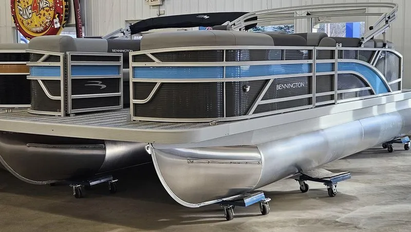 Slide: The Image of 2025 Bennington 22SLJ pontoon boat in showroom, featuring sleek design and modern amenities. - 3