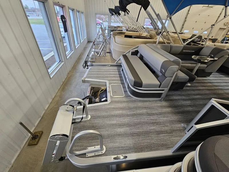 Slide: The Image of 2025 Bennington 22SLJ pontoon boat interior with gray seating and carpeted flooring. - 4