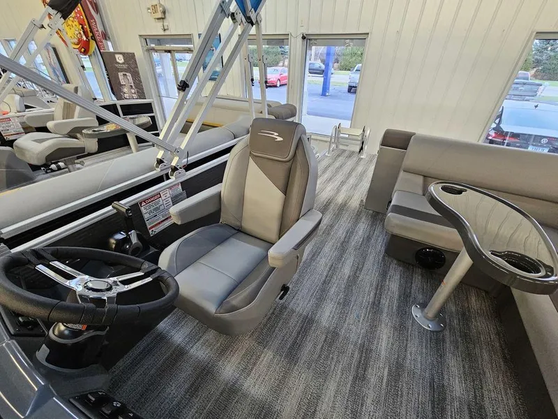 Slide: The Image of 2025 Bennington 22SLJ boat interior with captain's chair and seating area. - 7