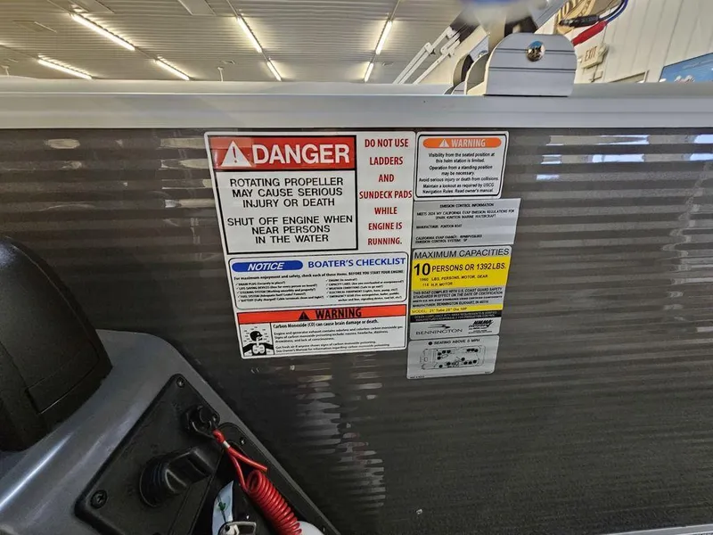 Slide: The Image of Warning labels on 2025 Bennington 22SLJ boat, highlighting safety precautions and capacity limits. - 8