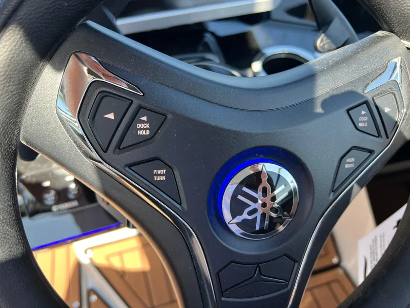 Slide: The Image of Steering wheel of 2025 Yamaha Boats 252SD with control buttons. - 18
