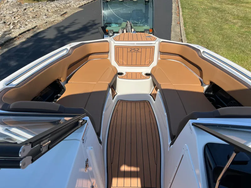 Slide: The Image of 2025 Yamaha Boats 252SD interior with tan seating and wood accents. - 20