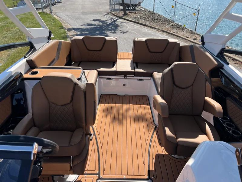 Slide: The Image of 2025 Yamaha Boats 252SD interior with luxurious brown seating and wood finish. - 24