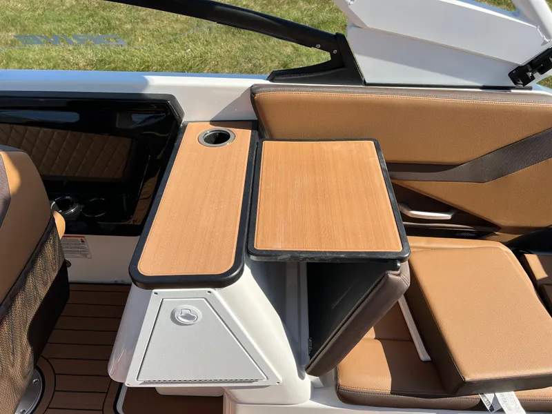 Slide: The Image of Interior of 2025 Yamaha Boats 252SD, featuring sleek seating and a wooden table. - 28