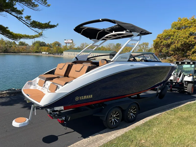 Slide: The Image of 2025 Yamaha Boats 252SD on trailer by a scenic lake. - 3