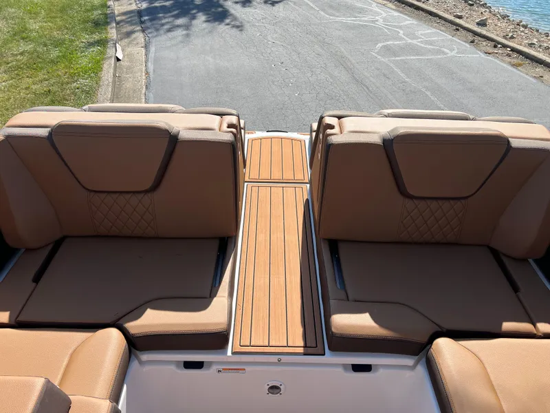Slide: The Image of 2025 Yamaha Boats 252SD interior with tan seating and wooden deck. - 30