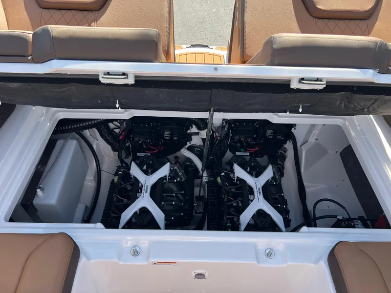 Slide: The Image of 2025 Yamaha Boats 252SD engine compartment with dual engines and tan seating. - 31