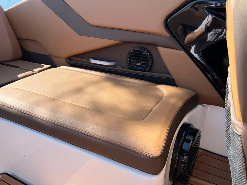 Slide: The Image of 2025 Yamaha Boats 252SD interior seating with tan upholstery and speaker detail. - 34
