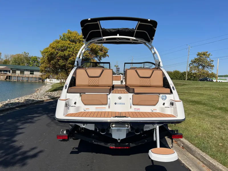 Slide: The Image of 2025 Yamaha Boats 252SD, rear view, docked on a sunny day. - 4