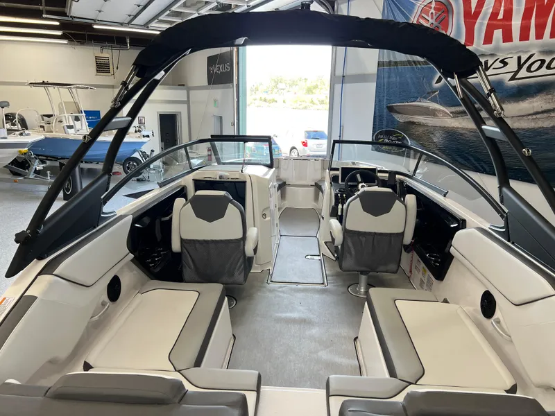 Slide: The Image of 2025 Yamaha Boats AR250 interior with seating and helm in showroom. - 5