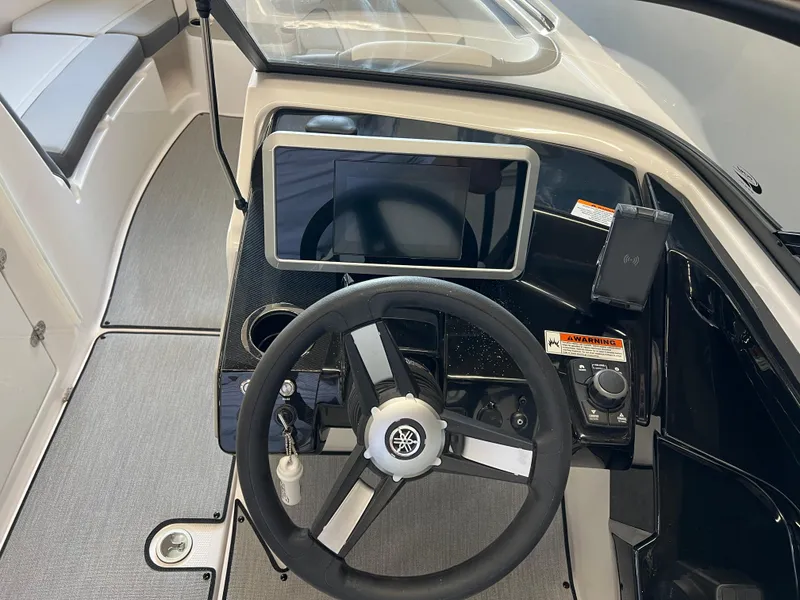 Slide: The Image of 2025 Yamaha Boats AR250 dashboard with steering wheel and touchscreen display. - 9