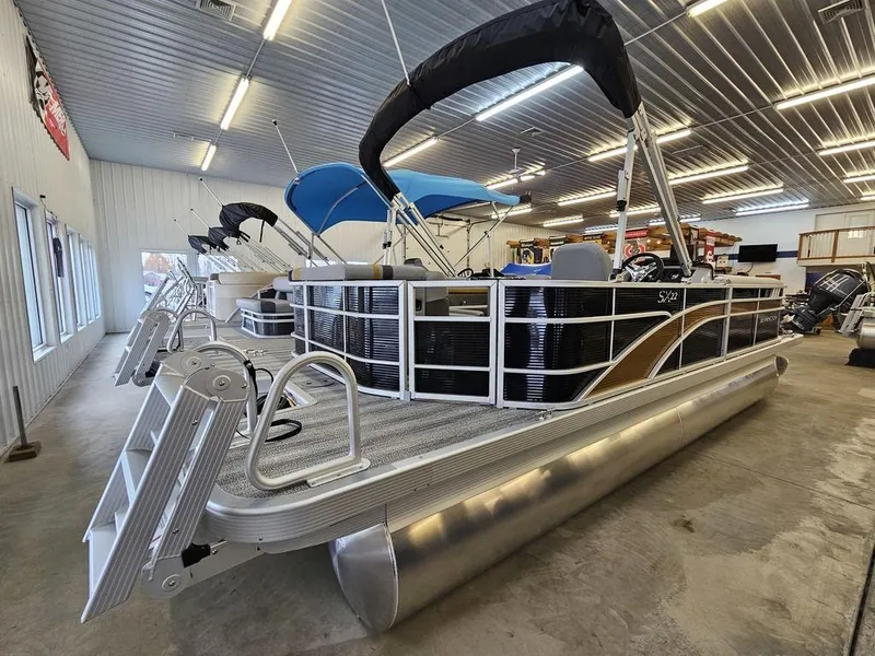 Slide: The Image of 2025 Bennington 22 SXL pontoon boat in showroom, featuring sleek design and modern amenities. - 3