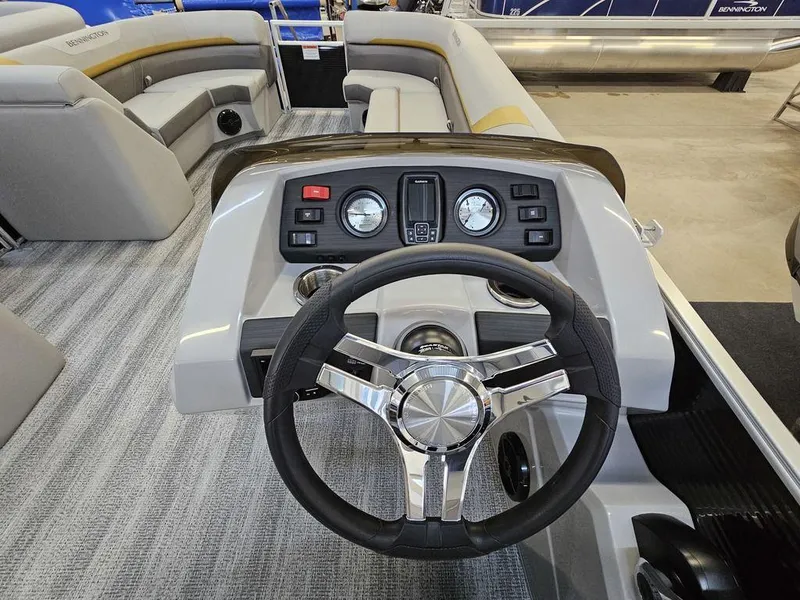 Slide: The Image of 2025 Bennington 22 SXL boat interior with steering wheel and dashboard controls. - 4