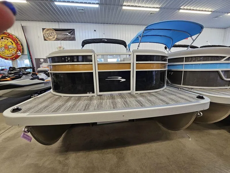 Slide: The Image of 2025 Bennington 22 SXL pontoon boat in showroom, featuring sleek design and modern amenities. - 7